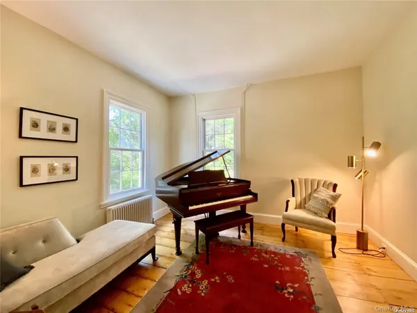 a living room with furniture a rug and a window