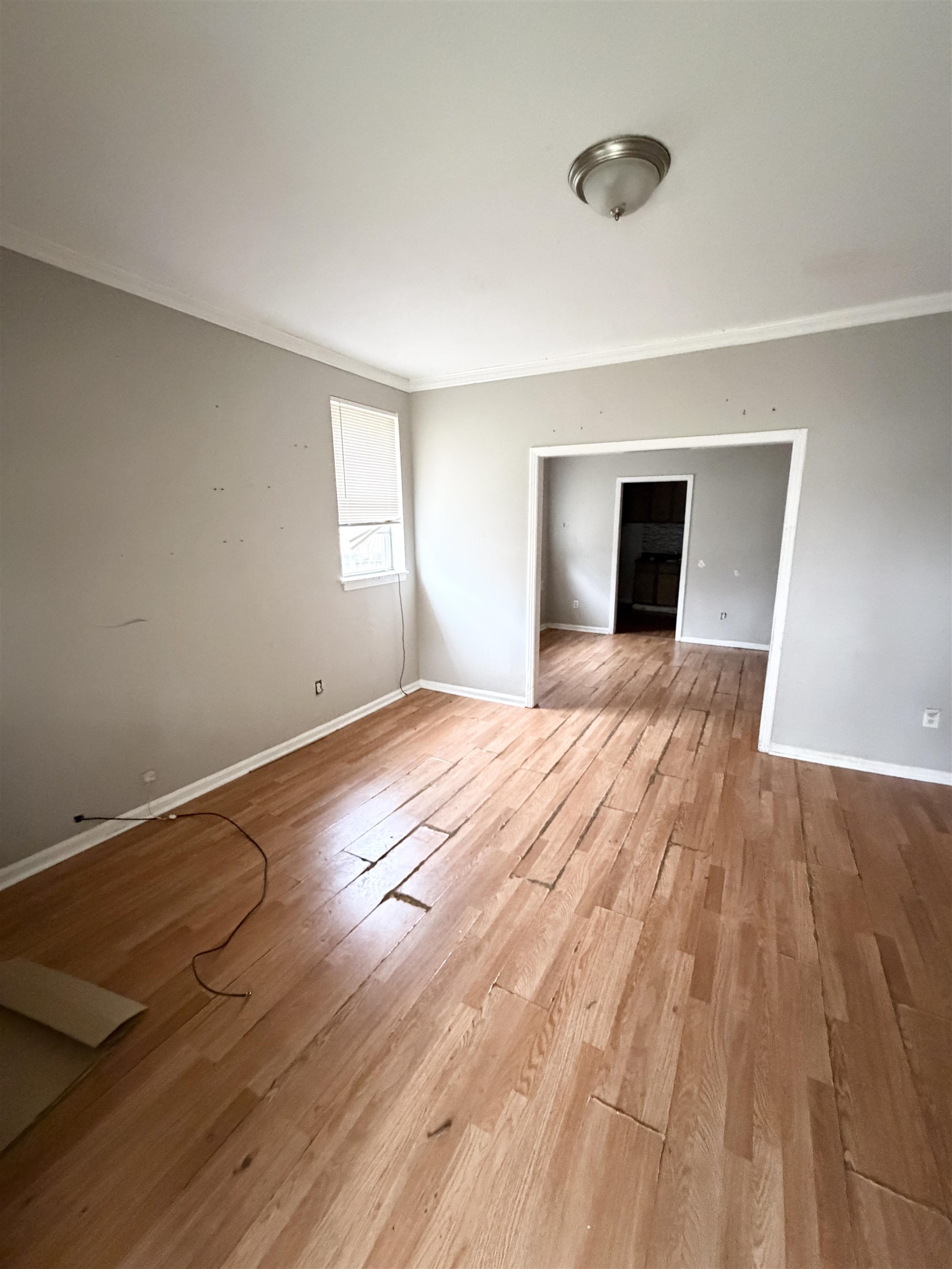 278 Hewlett Road Memphis, TN 38109 - Photo 2 of 13 a view of empty room with wooden floor and fan
