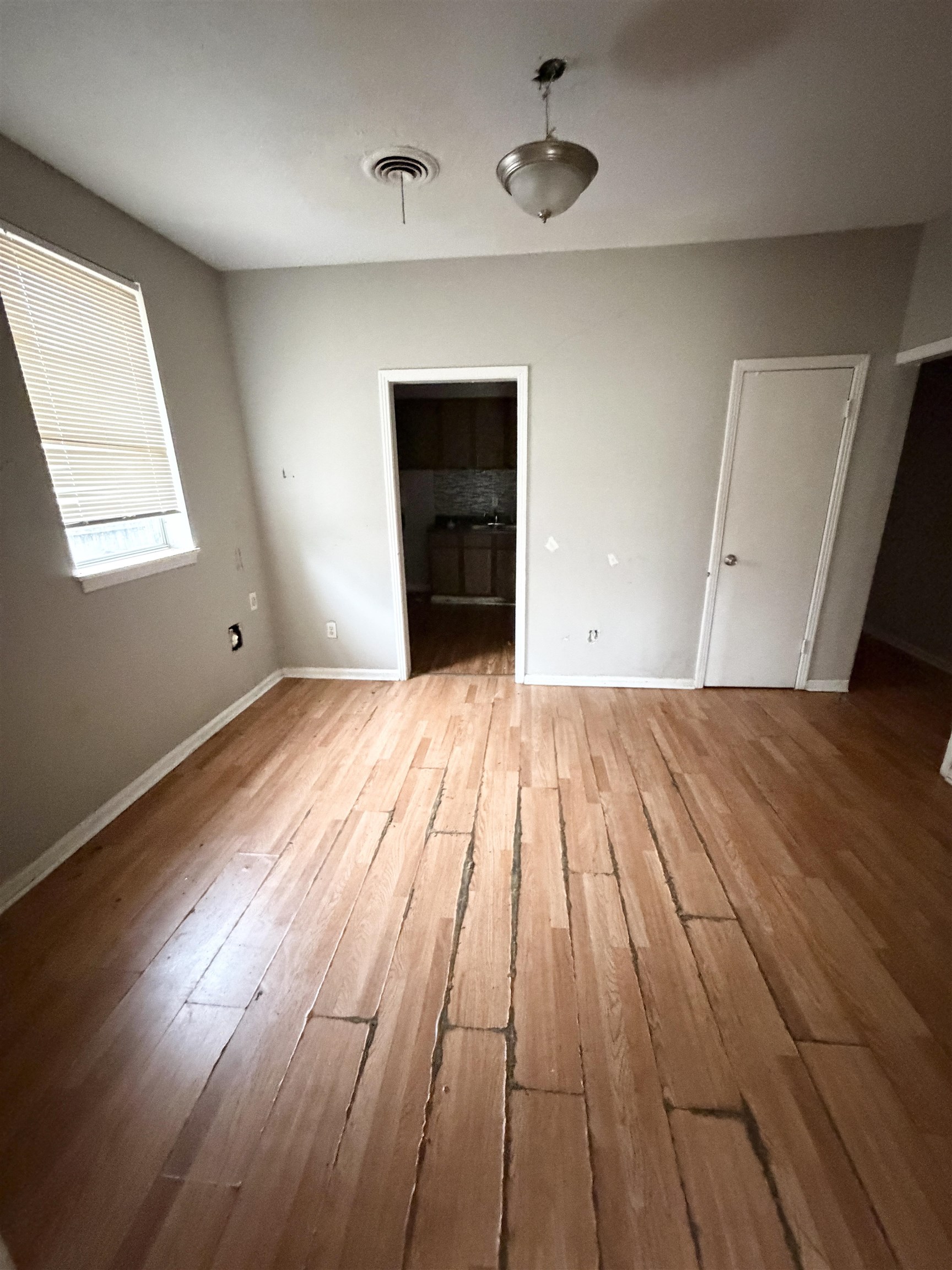 278 Hewlett Road Memphis, TN 38109 - Photo 4 of 13 wooden floor in an empty room with a window