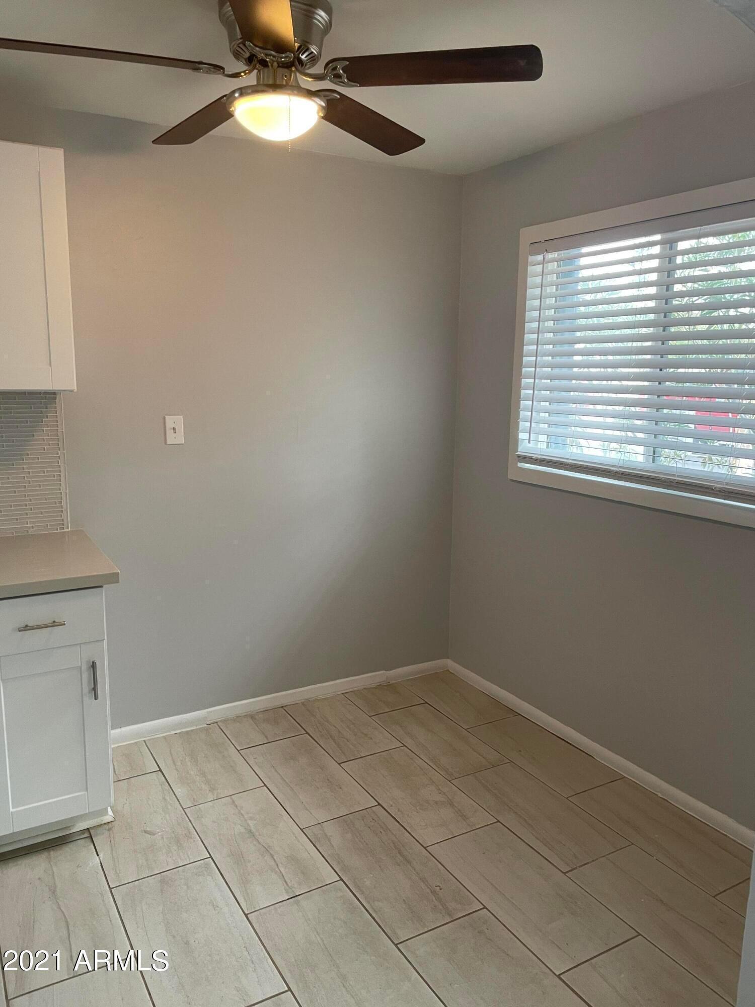2242 North 29th Place, Unit 3 Phoenix, AZ 85008 - Photo 6 of 19 a view of an empty room with a window