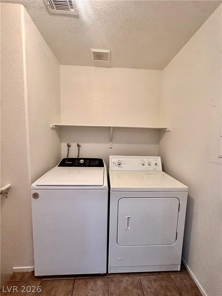 2053 Turquoise Ridge Street, Unit 202 Las Vegas, NV 89117 - Photo 9 of 18 Tiled flooring and a convenient storage shelf define this dedicated laundry alcove.