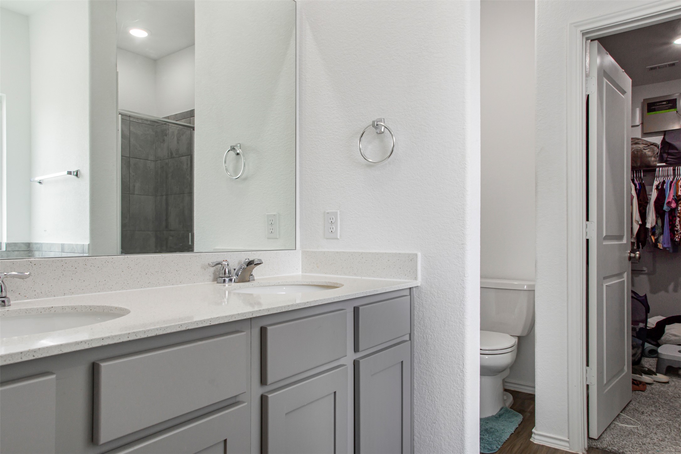 124 Cherry Ridge Road Georgetown, TX 78628 - Photo 18 of 23 Bathroom featuring a dual-sink vanity with light-toned countertops and gray cabinetry
