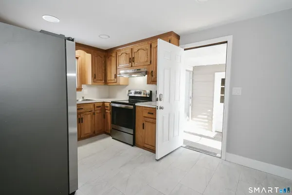 a kitchen with stainless steel appliances a sink and a refrigerator