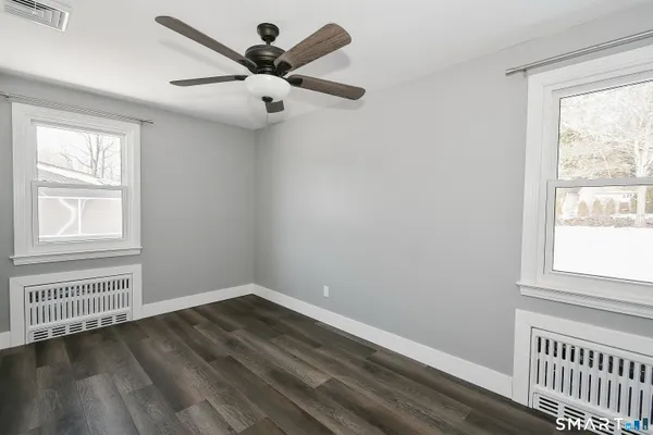 wooden floor in an empty room with a window