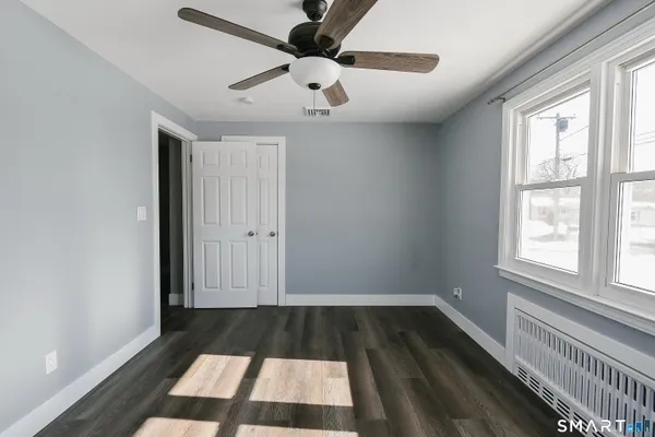 wooden floor in an empty room with a window