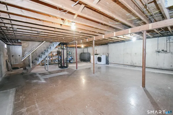 a view of a water heater room with stairs