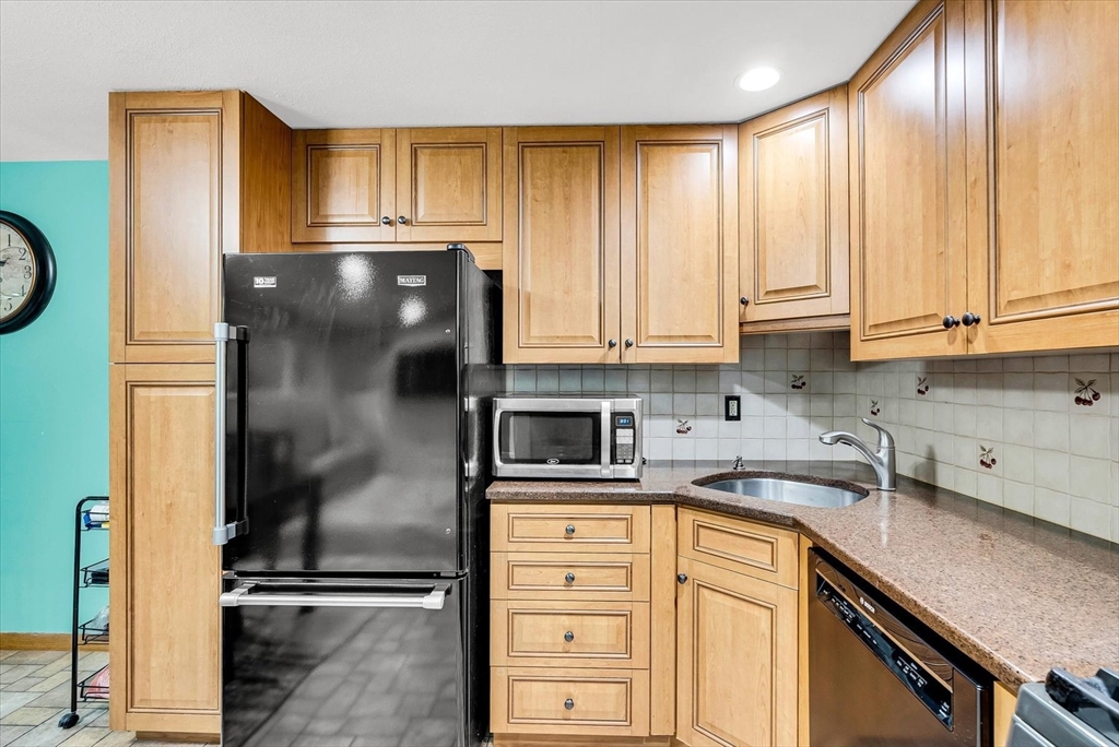 74 Meeting House Path, Unit 74 Ashland, MA 01721 - Photo 11 of 33 a kitchen with a refrigerator a sink and cabinets
