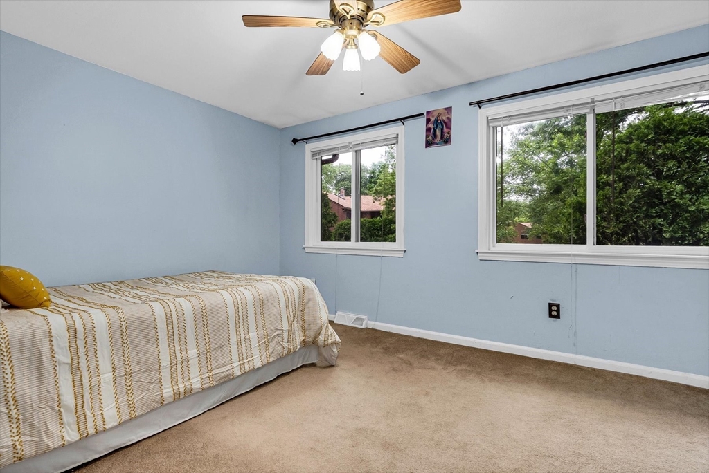 74 Meeting House Path, Unit 74 Ashland, MA 01721 - Photo 14 of 33 a bed sitting in a bedroom next to a window