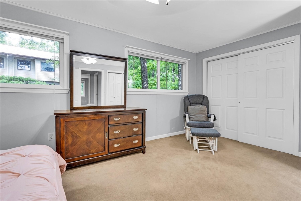 74 Meeting House Path, Unit 74 Ashland, MA 01721 - Photo 18 of 33 a living room with a bed furniture and a window