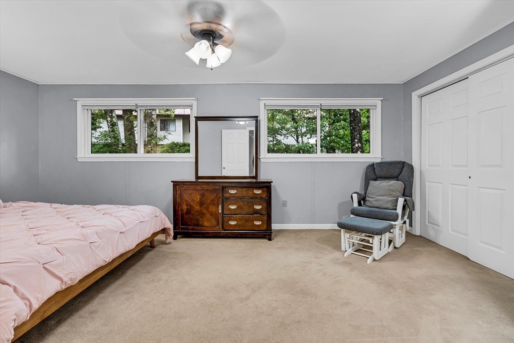 74 Meeting House Path, Unit 74 Ashland, MA 01721 - Photo 19 of 33 a bedroom with a bed and a chair