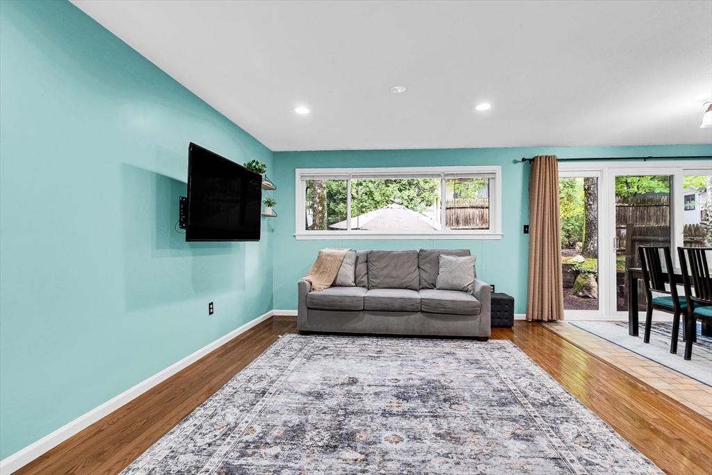 74 Meeting House Path, Unit 74 Ashland, MA 01721 - Photo 2 of 33 a living room with furniture and a flat screen tv