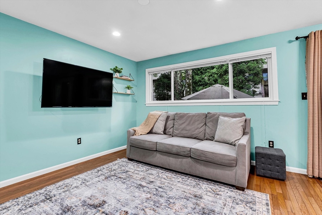 74 Meeting House Path, Unit 74 Ashland, MA 01721 - Photo 3 of 33 a living room with a flat screen tv and a large window