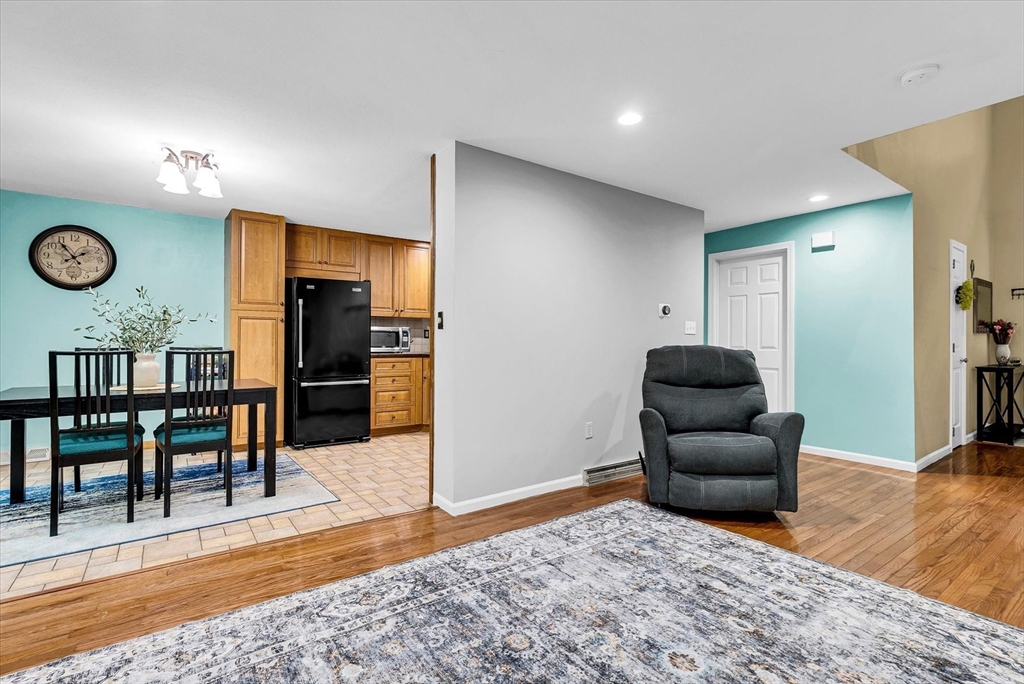 74 Meeting House Path, Unit 74 Ashland, MA 01721 - Photo 6 of 33 a living room with furniture and a wooden floor