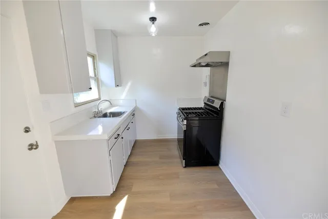 a kitchen with a sink and a stove