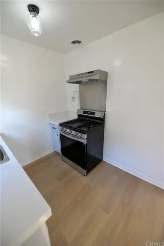 a kitchen with a stove and a cabinets