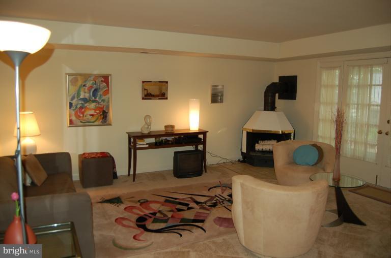 8663 Geren Road, Unit 265 Silver Spring, MD 20901 - Photo 5 of 9 a living room with furniture and a lamp