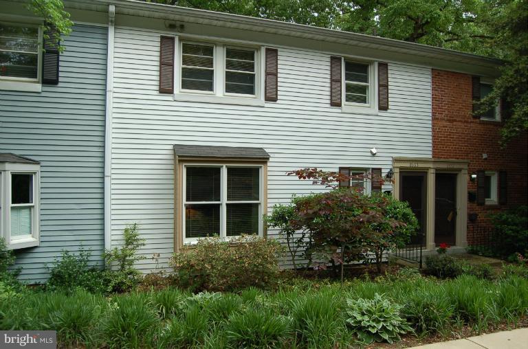 8663 Geren Road, Unit 265 Silver Spring, MD 20901 - Photo 9 of 9 a view of brick house with a yard and plants