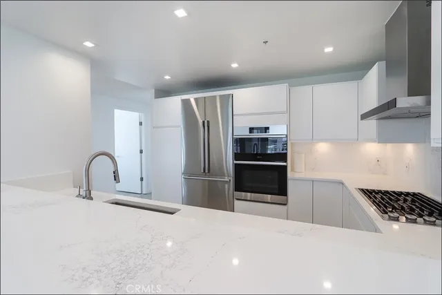 a kitchen with stainless steel appliances a refrigerator and a sink