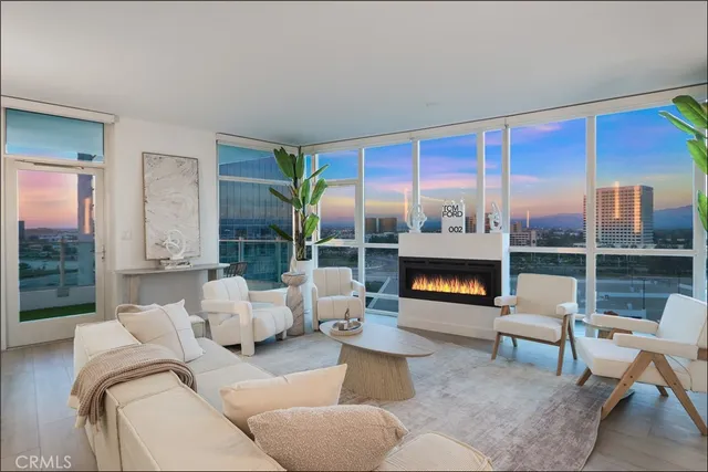 a living room with furniture and a floor to ceiling window