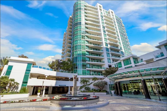 a front view of a building with streets and trees