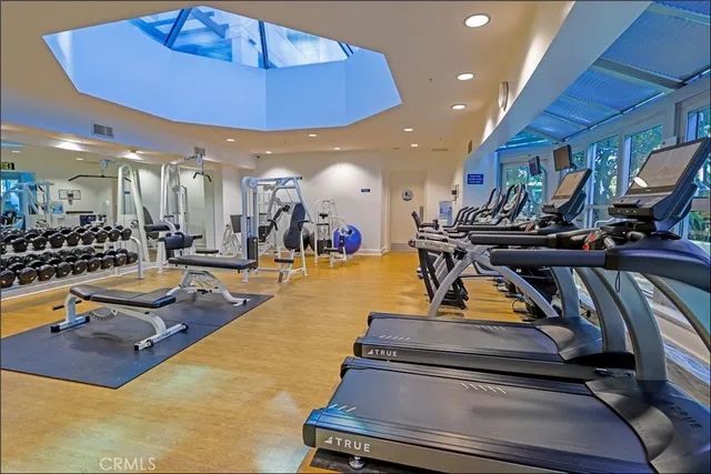 a view of a gym with lots of gym equipment