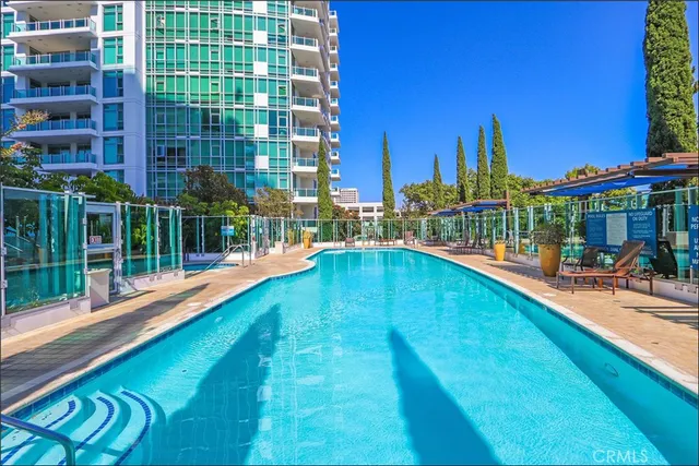 a swimming pool with outdoor seating and yard