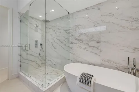 a bathroom with a bathtub and a shower