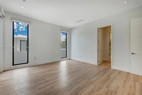 an empty room with wooden floor and closet