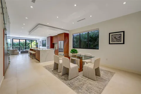 a living room with fireplace furniture and a large window