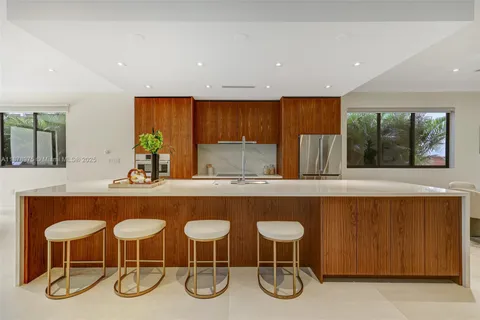 a kitchen with a table chairs sink and cabinets