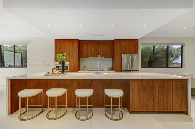 a kitchen with a table chairs sink and cabinets