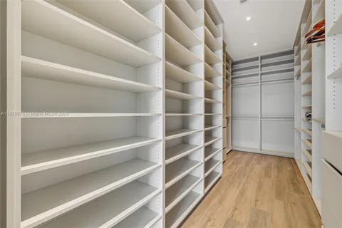 a view of walk in closet with empty racks