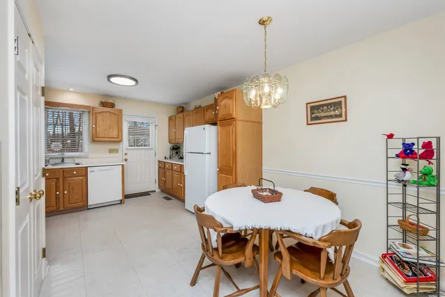 a view of a dining room with furniture and chandelier