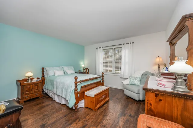 a bedroom with furniture and a wooden floor