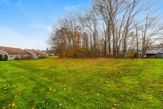 a view of outdoor space with deck area and trees all around