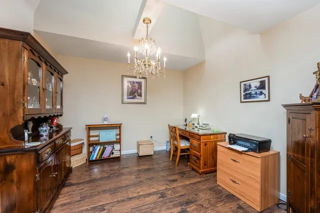 a view of a dining room with furniture and chandelier