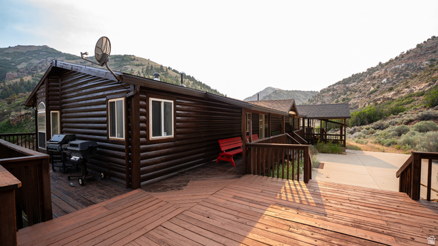 7500 Spring Canyon Road Helper, UT 84526 - Photo 7 of 64 Expansive outdoor deck featuring wood flooring and railings, surrounding a log-style exterior
