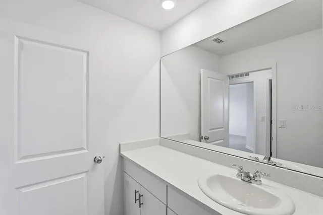 a bathroom with a double vanity sink mirror and shower