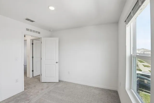 a view of an empty room with a window