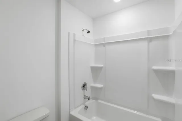 a view of a house with backyard and a garage