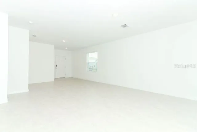a view of a kitchen with a sink and a refrigerator