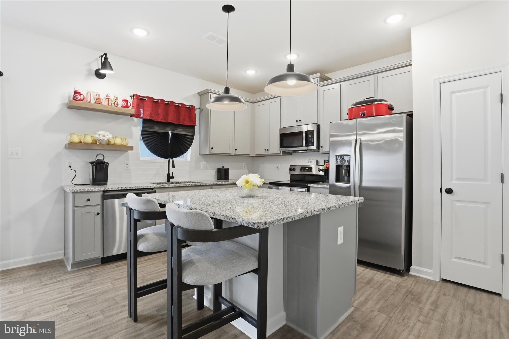 76 Diving Scaup Road Hedgesville, WV 25427 - Photo 6 of 48 a kitchen with stainless steel appliances granite countertop a sink a refrigerator and a stove