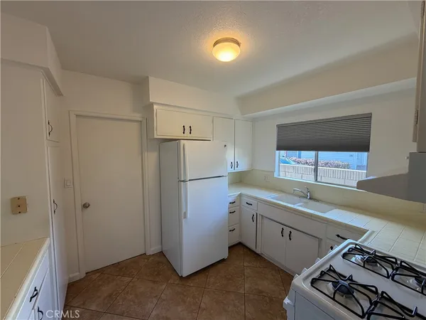a kitchen with a refrigerator and a sink