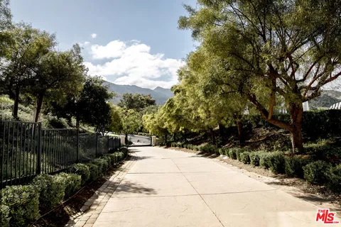 a view of a pathway with a wrought fence
