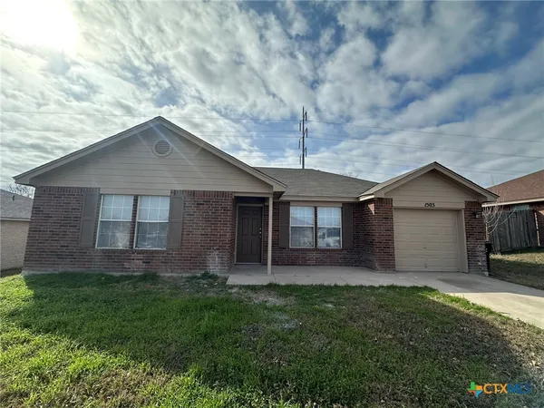 a view of a house with a yard and fence