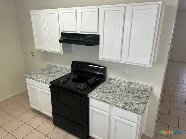 a kitchen with granite countertop cabinets and sink