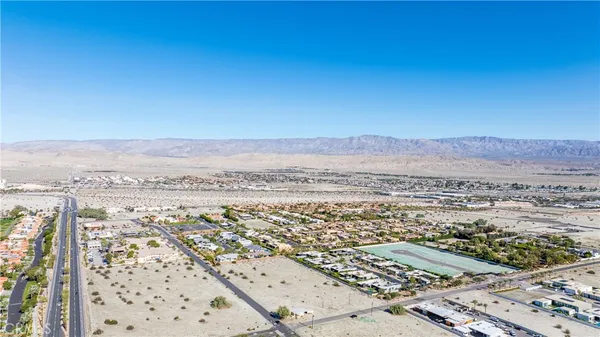 an aerial view of residential house and sandy dunes