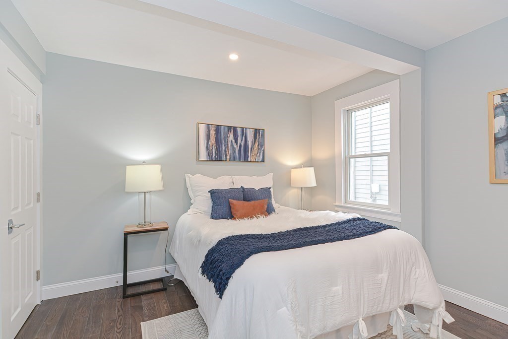 287 Cherry Street, Unit 1 Newton, MA 02465 - Photo 13 of 30 a bedroom with a bed and a night stand