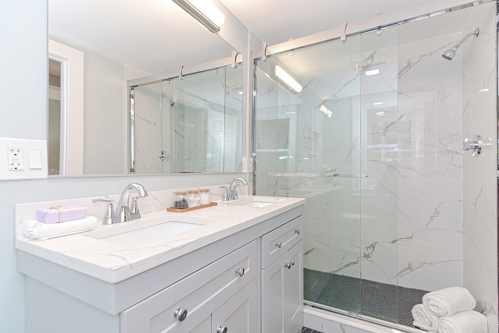 287 Cherry Street, Unit 1 Newton, MA 02465 - Photo 14 of 30 a bathroom with a sink vanity granite tub and shower
