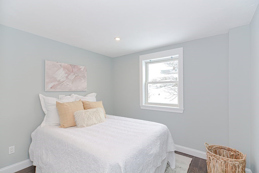 287 Cherry Street, Unit 1 Newton, MA 02465 - Photo 15 of 30 a bedroom with a bed and a window